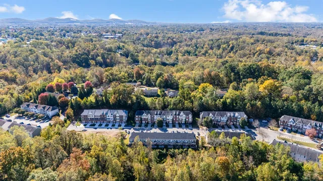 a view of a hallway with living room and a view of bathroom