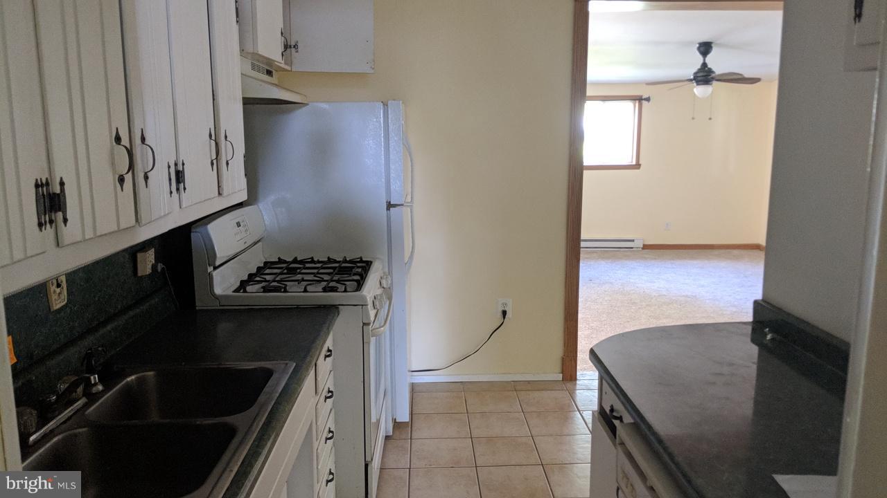 1 Wengate Road Owings Mills, MD 21117 - Photo 5 of 24 a kitchen with granite countertop a stove and a refrigerator