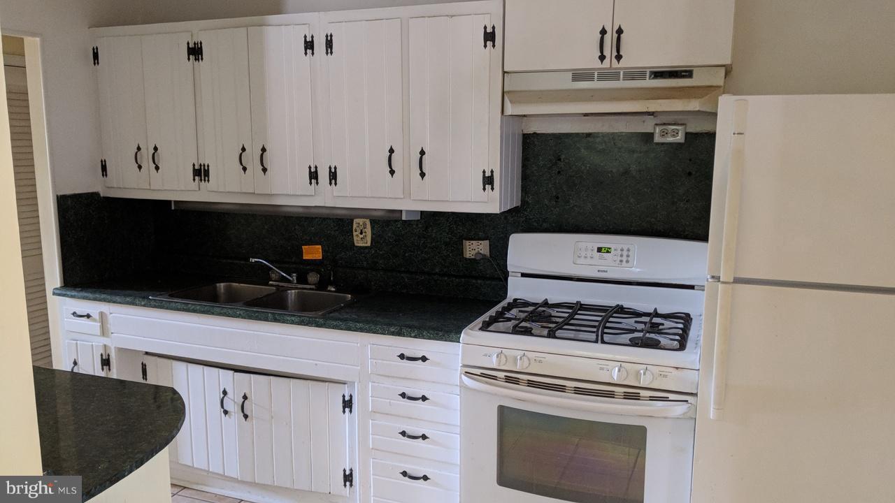 1 Wengate Road Owings Mills, MD 21117 - Photo 9 of 24 a kitchen with granite countertop a sink stove and white cabinets