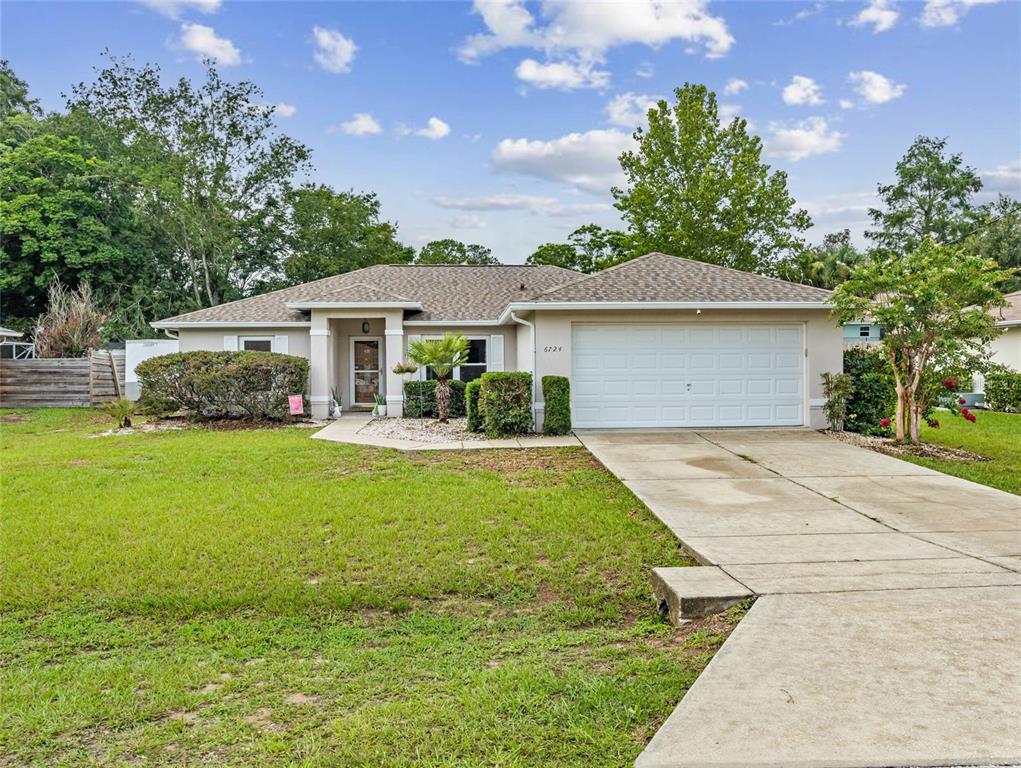 6724 Cherry Road Ocala, FL 34472 - Photo 1 of 29 a front view of a house with garden