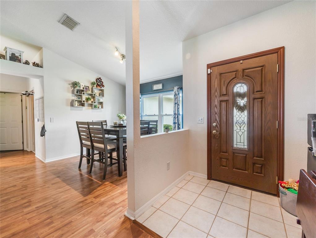 6724 Cherry Road Ocala, FL 34472 - Photo 18 of 29 a view of a hallway with wooden floor and furniture