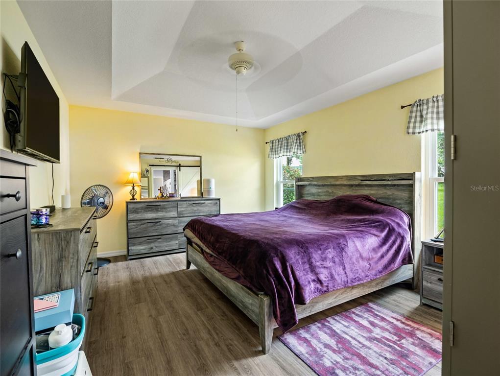 6724 Cherry Road Ocala, FL 34472 - Photo 19 of 29 a bedroom with a bed and flat tv screen on dresser