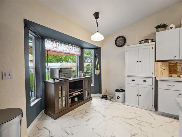 a view of a patio with table and chairs potted plants with wooden floor
