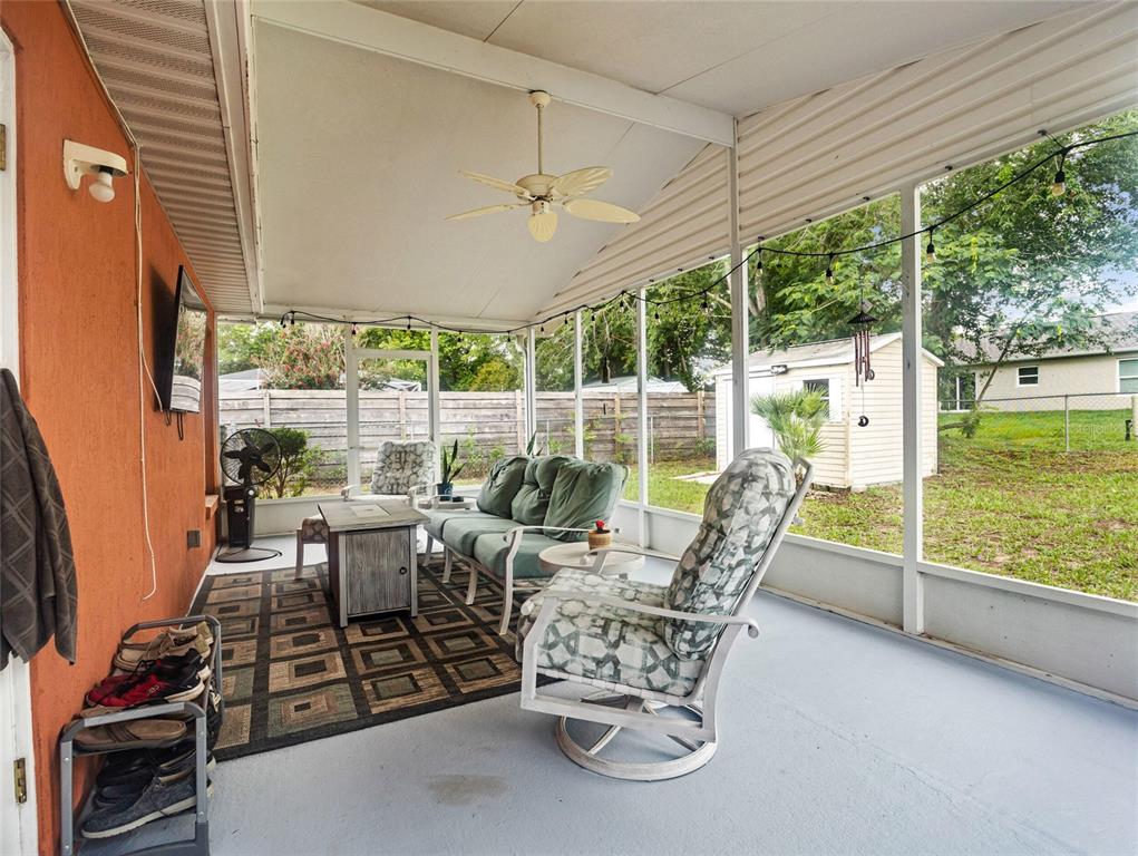 6724 Cherry Road Ocala, FL 34472 - Photo 25 of 29 a view of a patio with table and chairs potted plants with wooden floor