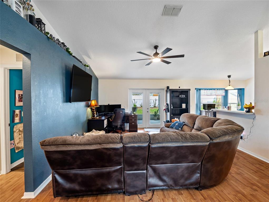 6724 Cherry Road Ocala, FL 34472 - Photo 6 of 29 a living room with furniture a ceiling fan and a flat screen tv