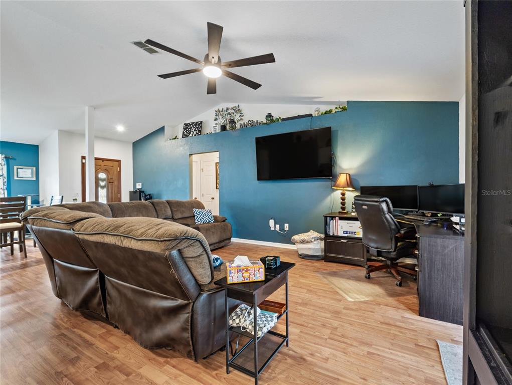 6724 Cherry Road Ocala, FL 34472 - Photo 7 of 29 a living room with furniture a ceiling fan and a flat screen tv