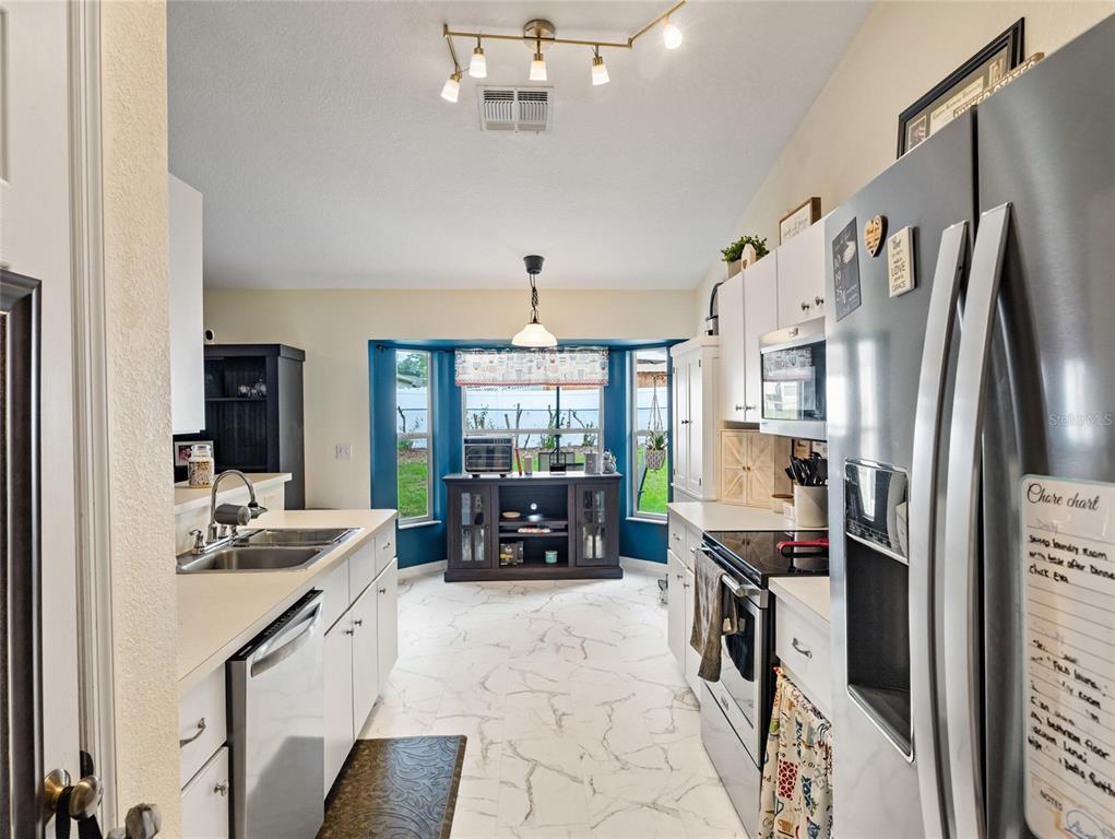 6724 Cherry Road Ocala, FL 34472 - Photo 8 of 29 a kitchen with stainless steel appliances granite countertop a refrigerator and a sink