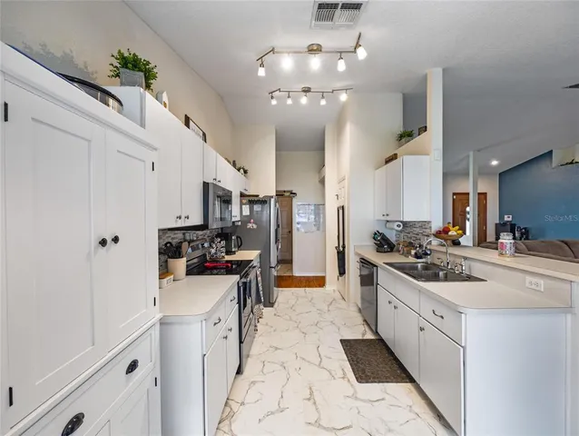 a kitchen with a sink and stove