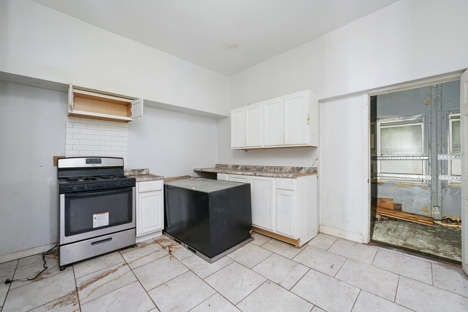 58 West 72nd Street Chicago, IL 60621 - Photo 12 of 28 a kitchen with stainless steel appliances granite countertop a stove and a sink
