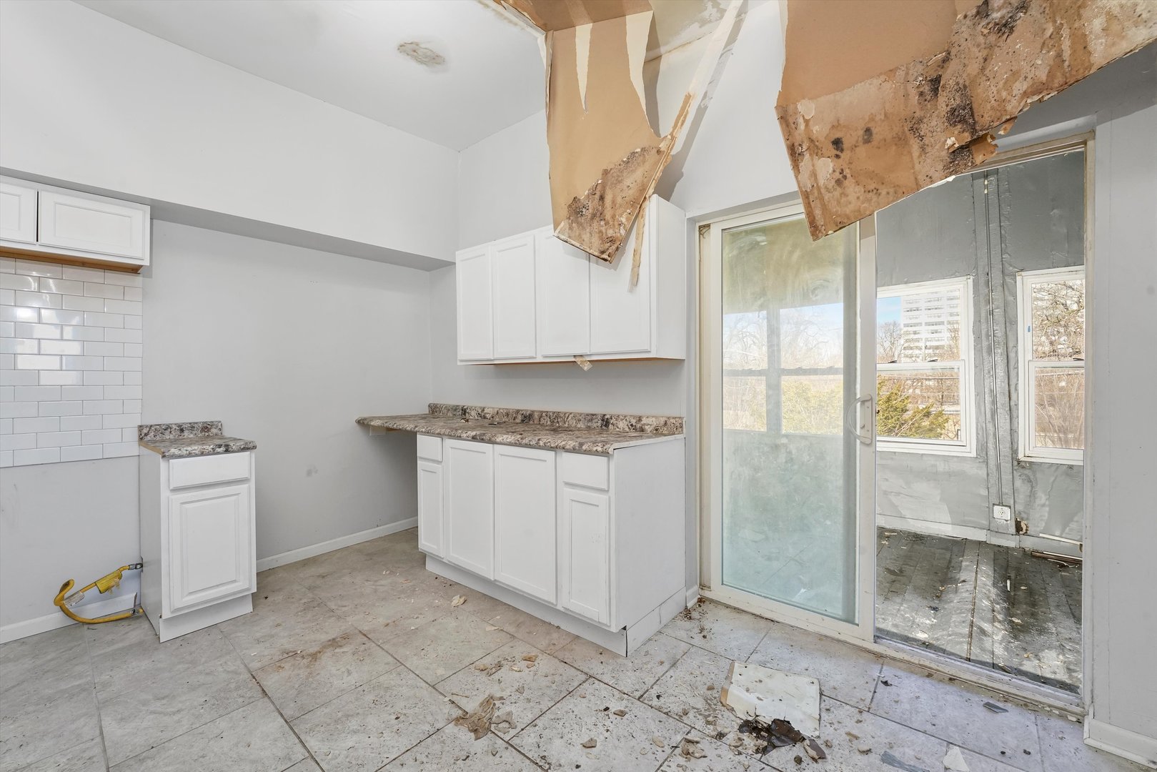 58 West 72nd Street Chicago, IL 60621 - Photo 18 of 28 a room with white cabinets and a stove