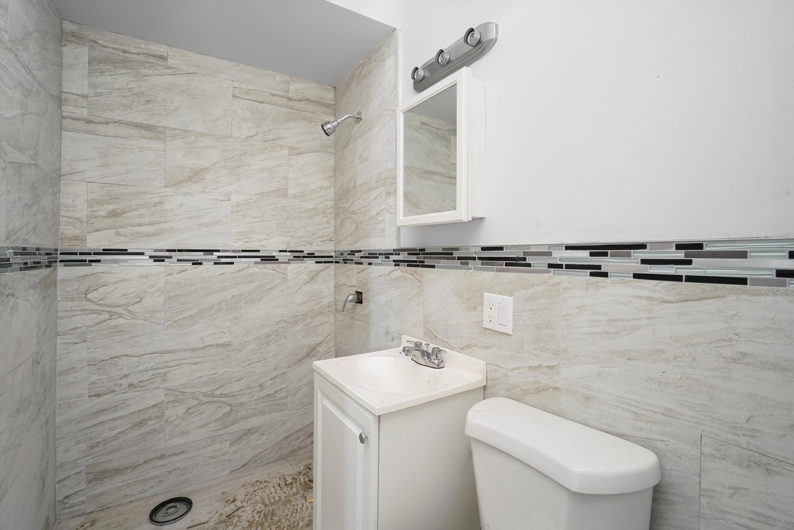 58 West 72nd Street Chicago, IL 60621 - Photo 22 of 28 a bathroom with a toilet sink and mirror