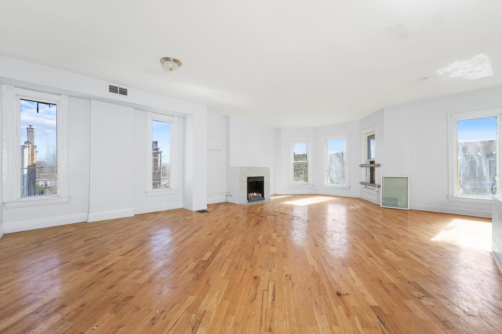 58 West 72nd Street Chicago, IL 60621 - Photo 23 of 28 a view of empty room with wooden floor and fireplace