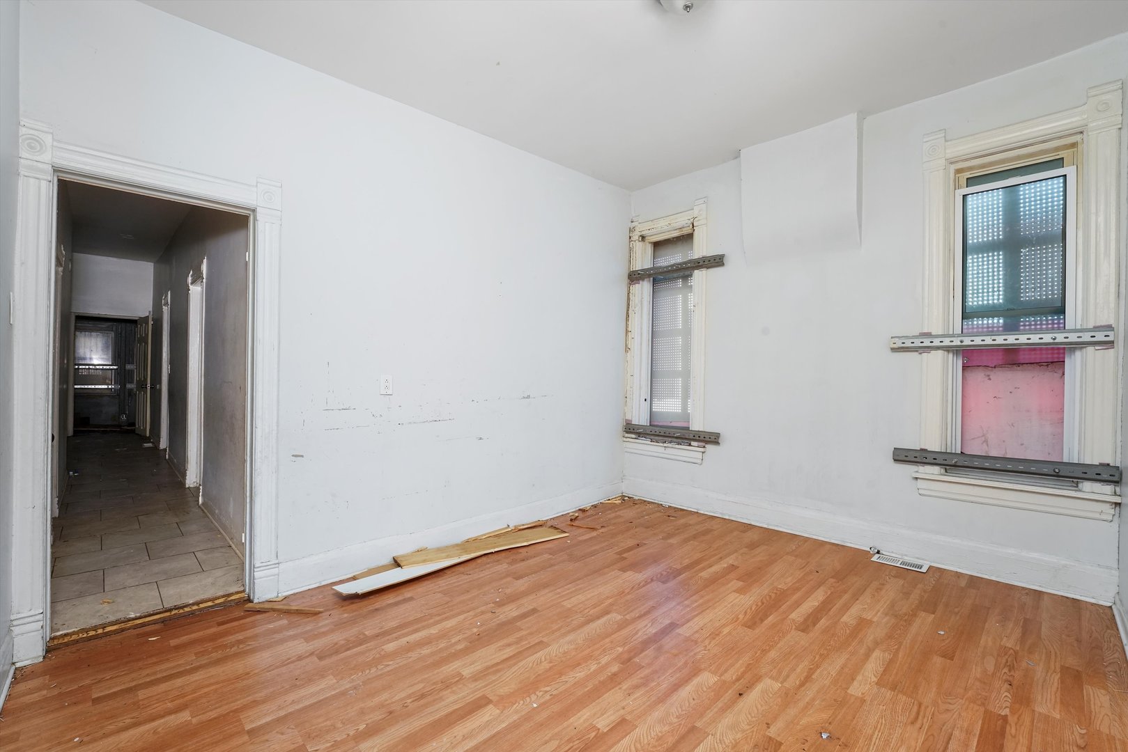 58 West 72nd Street Chicago, IL 60621 - Photo 7 of 28 wooden floor in an empty room with a window
