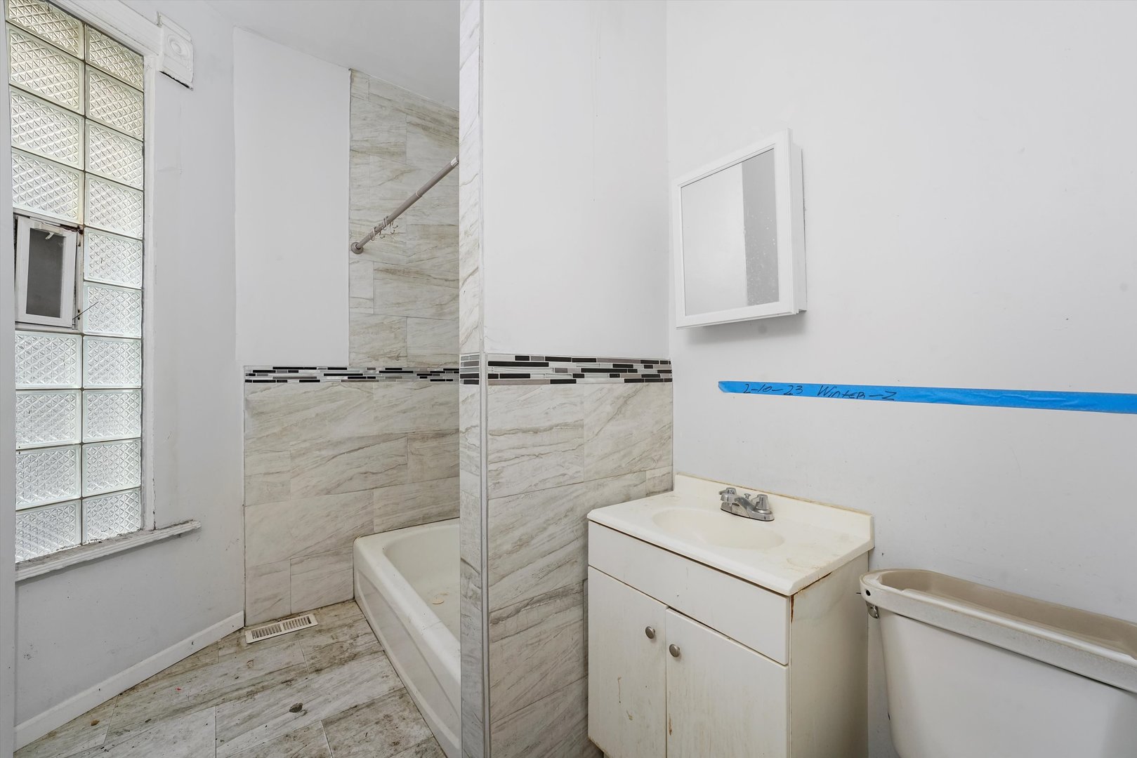 58 West 72nd Street Chicago, IL 60621 - Photo 9 of 28 a bathroom with a sink a toilet and shower