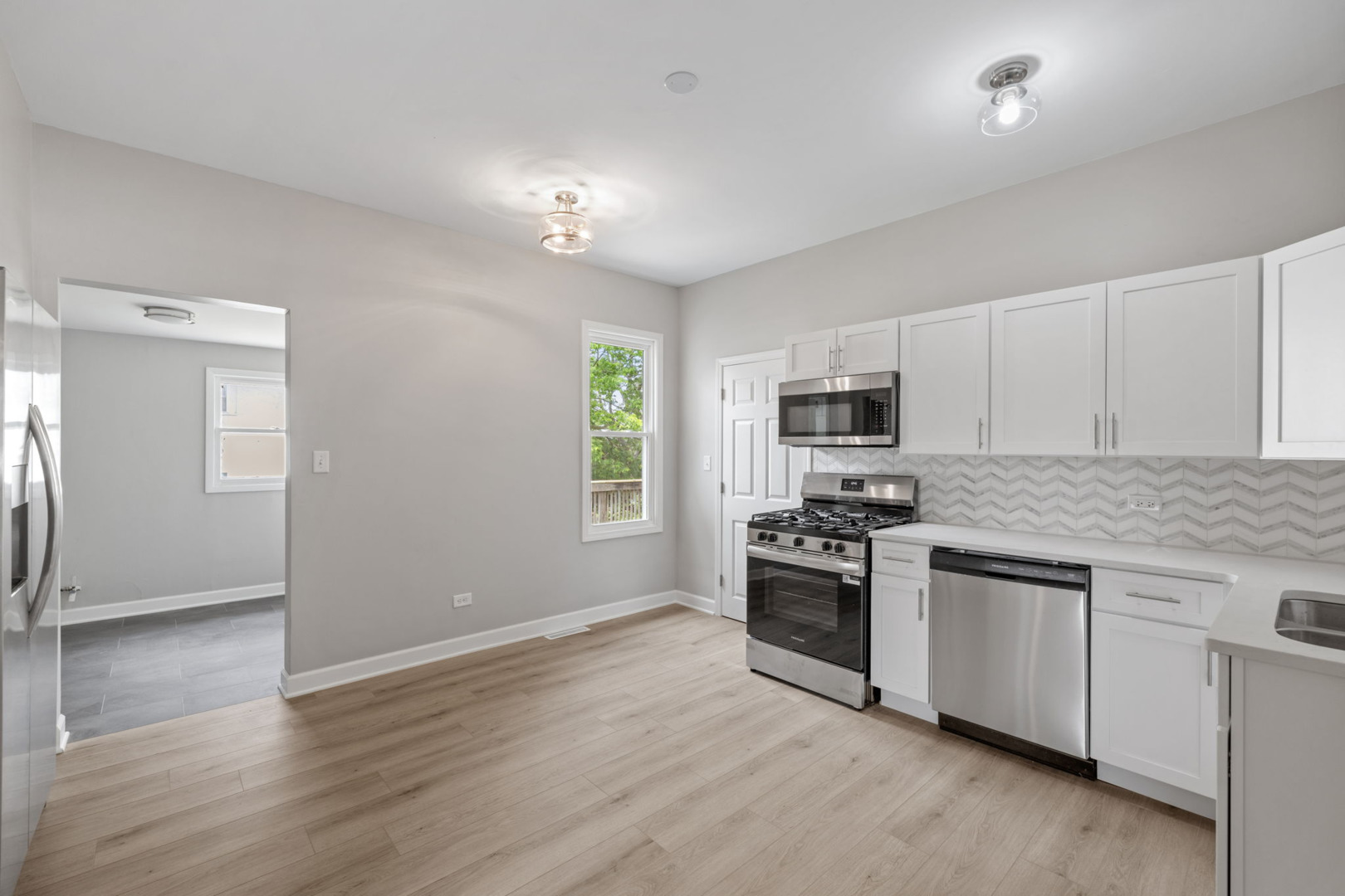 1729 South Hamilton Street Lockport, IL 60441 - Photo 11 of 18 an open kitchen with granite countertop stainless steel appliances and wooden floor