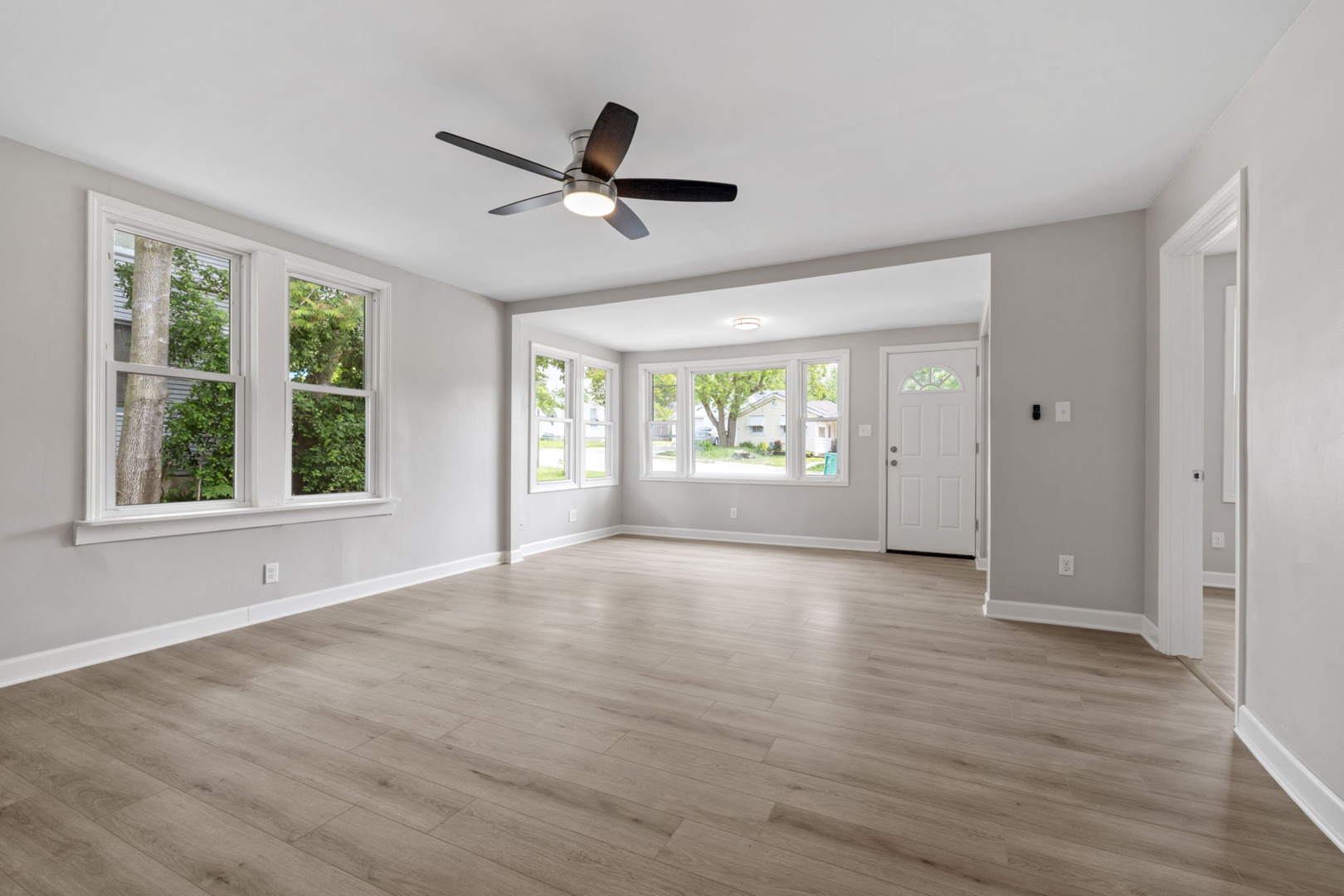 1729 South Hamilton Street Lockport, IL 60441 - Photo 4 of 18 a view of an empty room with a window and wooden floor