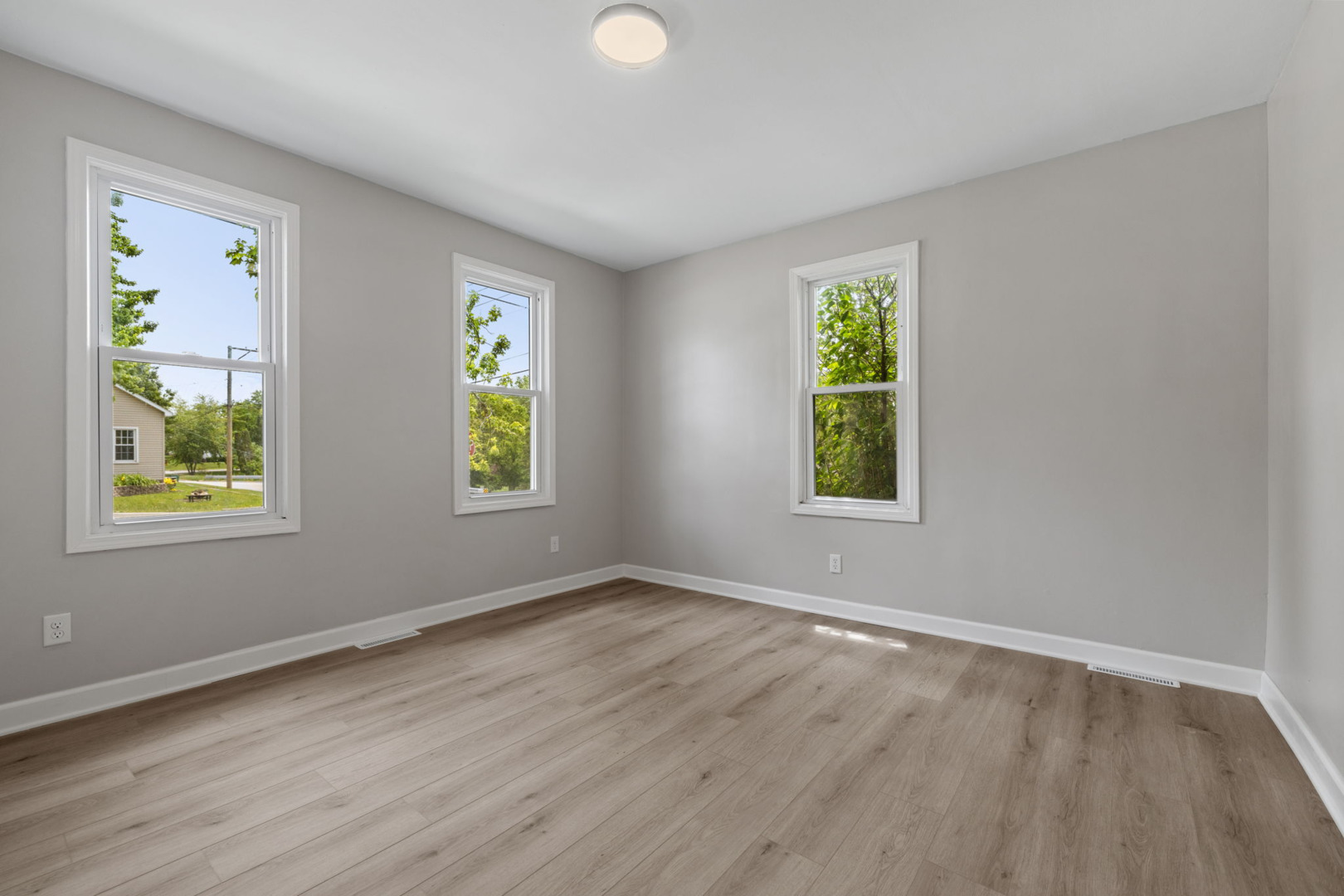 1729 South Hamilton Street Lockport, IL 60441 - Photo 5 of 18 a view of an empty room with window and wooden floor