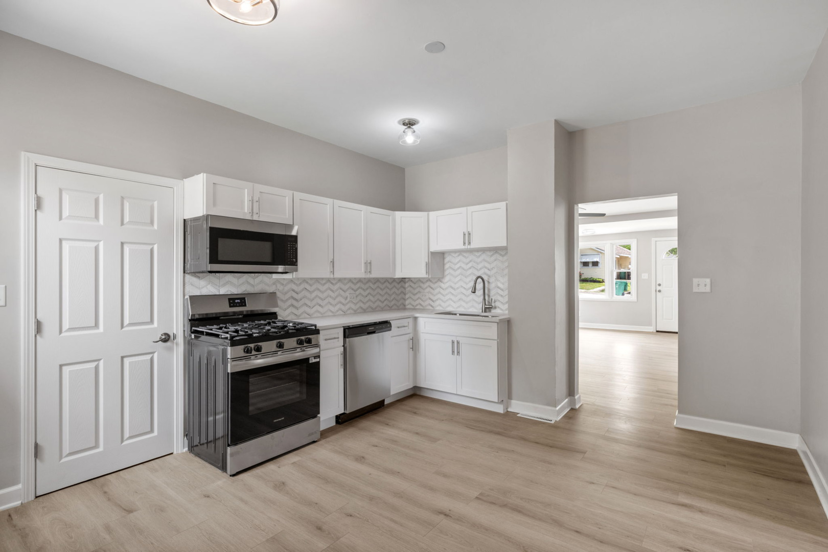 1729 South Hamilton Street Lockport, IL 60441 - Photo 9 of 18 a kitchen with granite countertop white cabinets and stainless steel appliances