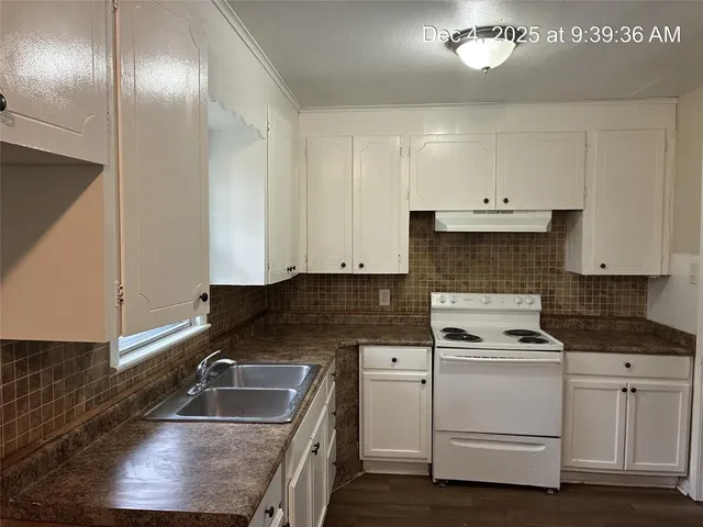 a kitchen that has a sink and cabinets