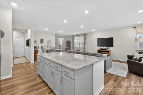 a kitchen with stainless steel appliances granite countertop a kitchen island a stove and a sink