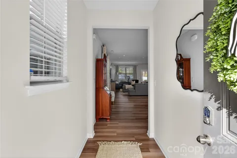 a view of a hallway with a livingroom and a window