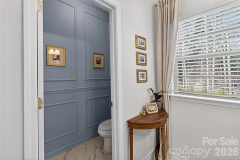 a bathroom with a toilet a sink and a window