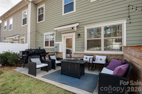 a outdoor living space with patio couches and a potted plant