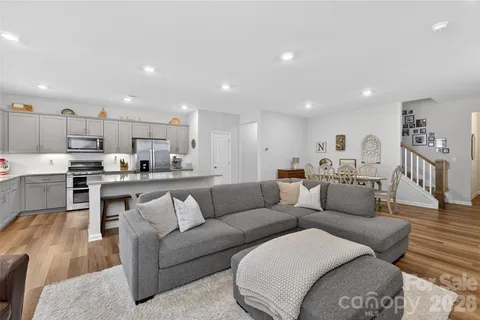 a living room with furniture and kitchen view