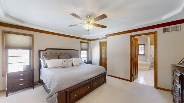 a bedroom with a bed and a chandelier