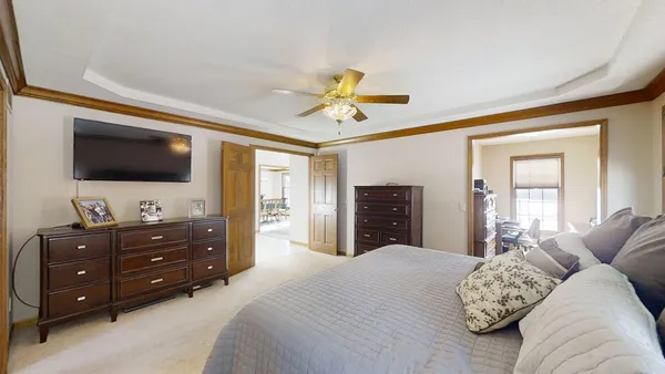 a bedroom with a bed and a chandelier