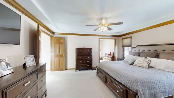 a bedroom with a bed and a chandelier