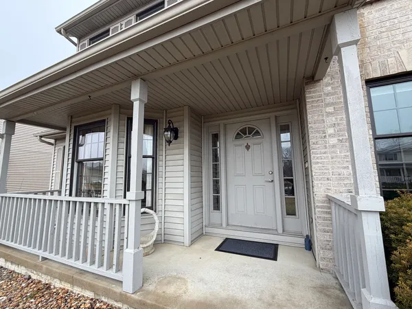 a view of a door and chair and floor to ceiling window