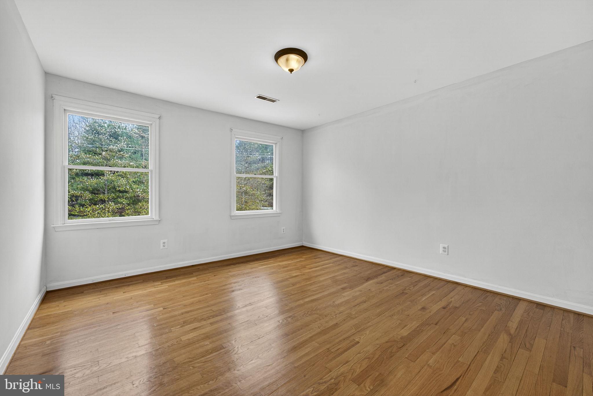 10507 Cliff Mills Road Marshall, VA 20115 - Photo 28 of 56 an empty room with wooden floor and windows