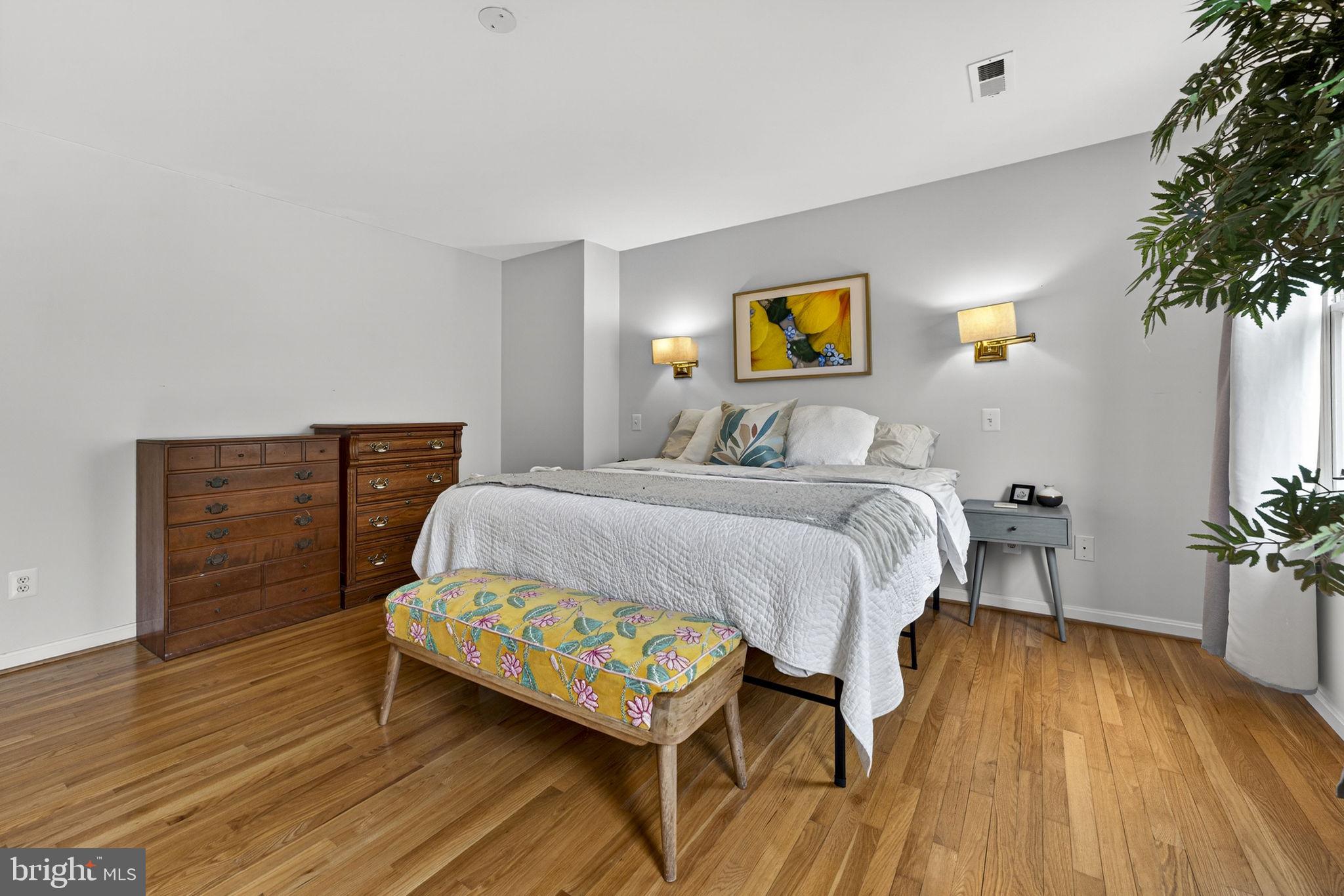 10507 Cliff Mills Road Marshall, VA 20115 - Photo 36 of 56 a bedroom with a bed and a potted plant on dresser