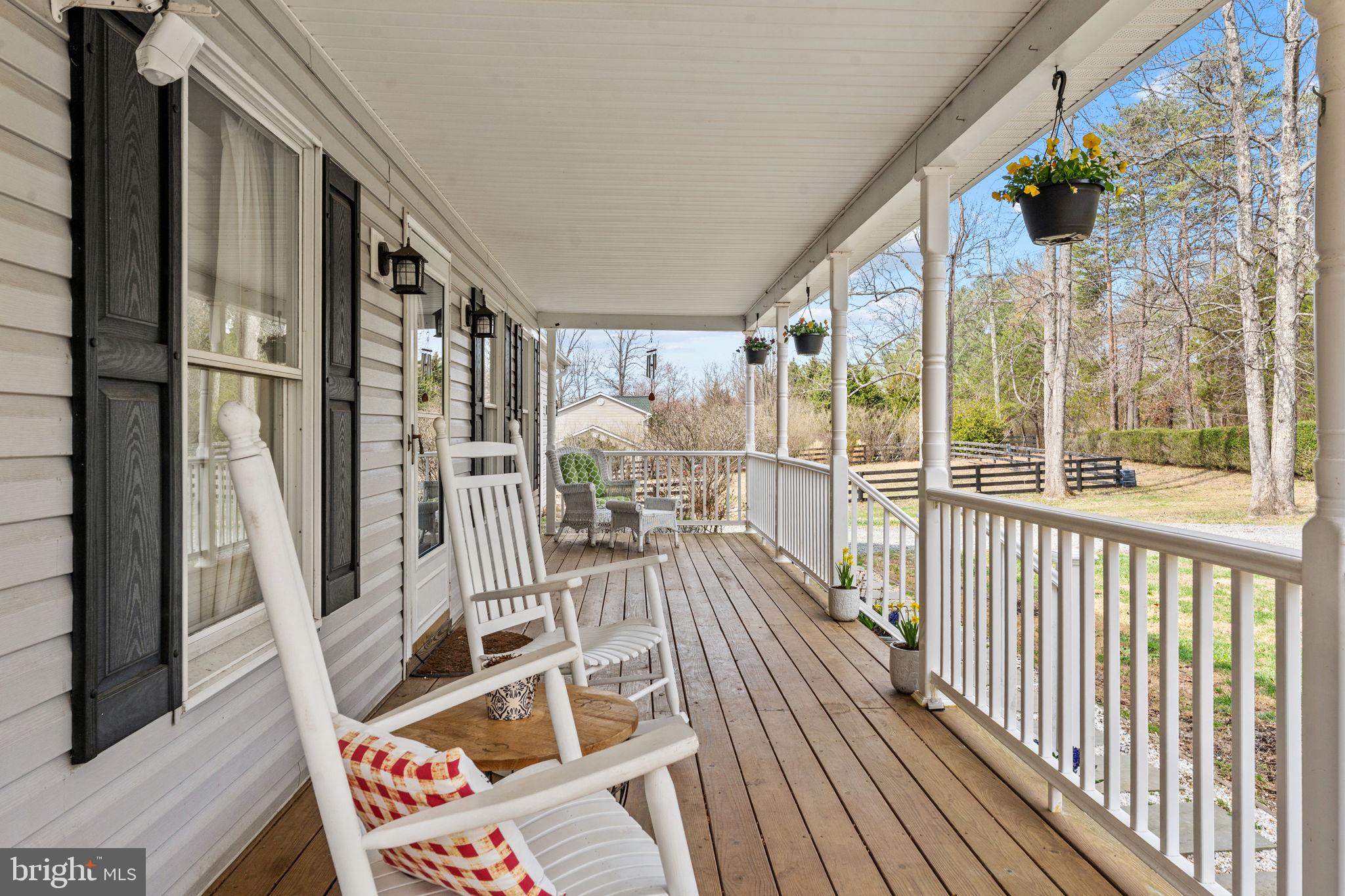 10507 Cliff Mills Road Marshall, VA 20115 - Photo 4 of 56 a view of a balcony with floor to ceiling window wooden floor
