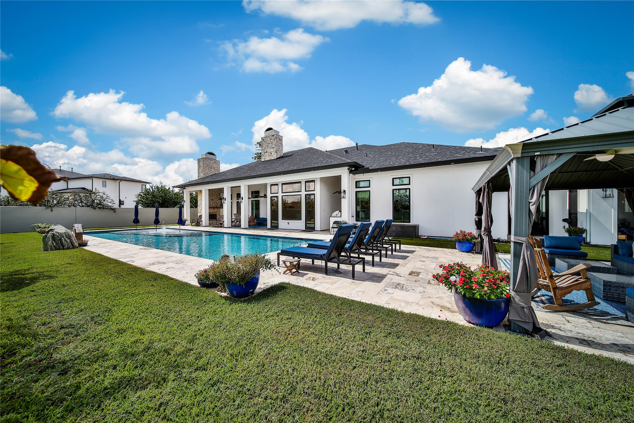 24718 Shadow Pond Spring, TX 77389 - Photo 40 of 49 Luxurious outdoor oasis featuring a pristine pool, elegant patio seating, and a stylish gazebo, perfect for relaxation and entertaining.