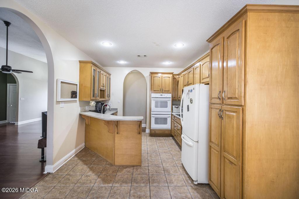 80 Mallard Pointe Kathleen, GA 31047 - Photo 13 of 34 a view of a kitchen with refrigerator and a stove
