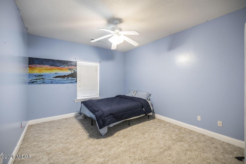 80 Mallard Pointe Kathleen, GA 31047 - Photo 22 of 34 a room with a bed and a chandelier