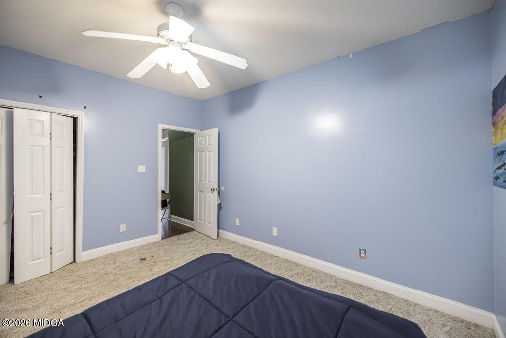 80 Mallard Pointe Kathleen, GA 31047 - Photo 23 of 34 a bedroom with a bed and a chandelier