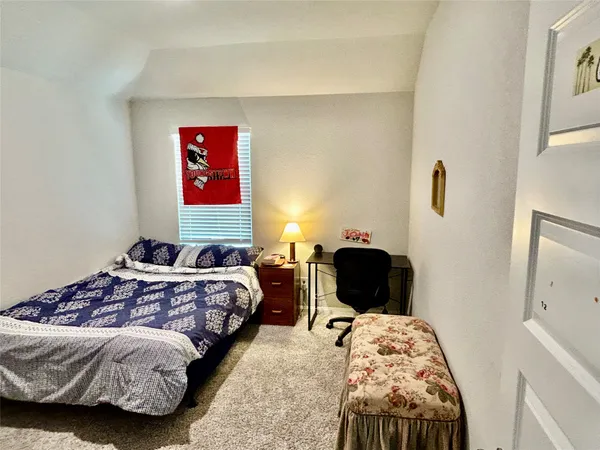 a bedroom with bed and a window