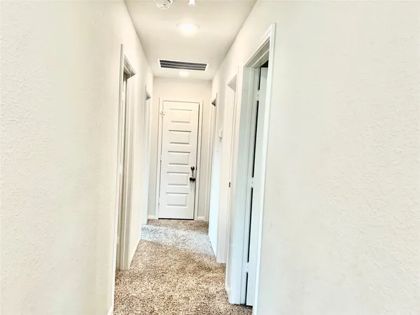 a view of livingroom with hardwood floor and hallway