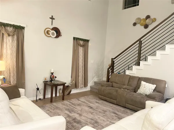 a living room with furniture and a large window