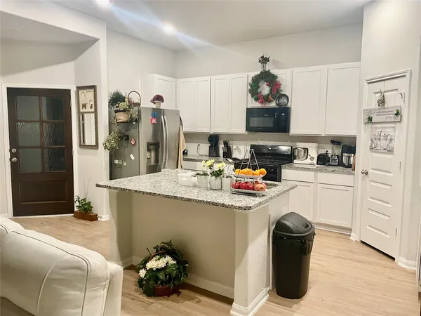 a kitchen with a sink and refrigerator