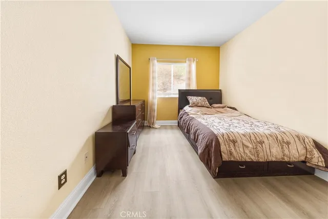 a bed sitting in a bedroom next to a window