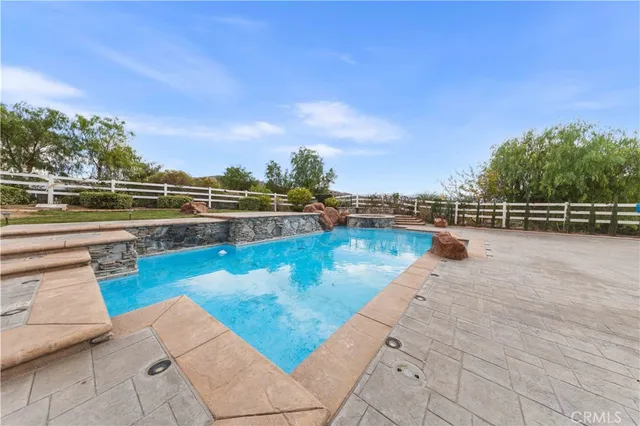 a view of swimming pool with outdoor seating and city view