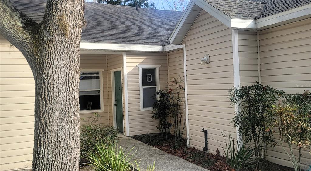 4700 Southwest Archer Road, Unit 117 Gainesville, FL 32608 - Photo 1 of 1 a view of a porch with plants and wooden fence