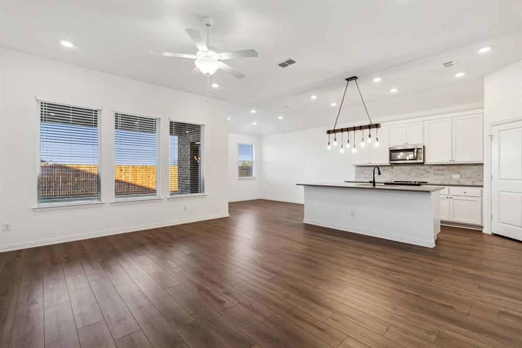a view of kitchen with cabinets and wooden floor