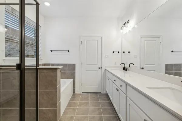 a bathroom with a double vanity sink and mirror