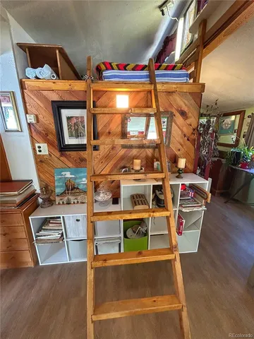 a view of a room with wooden floor and windows