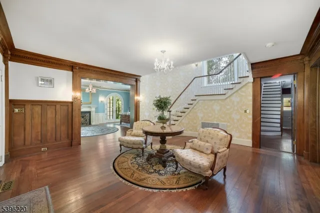 a view of an empty room with exposed radiator and fireplace